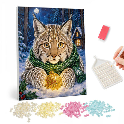 Lynx Cradling a Golden Bauble pearl painting – Lynx in a green knit scarf holding a glowing gold bauble in a snowy forest at night