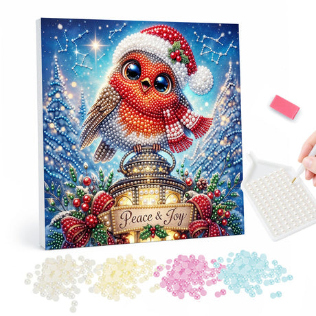 Santa-Hat Robin Under the Stars pearl painting – Robin in a Santa hat and scarf perched on a glowing lantern above a Peace and Joy banner