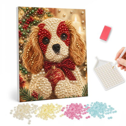 Spaniel Pup with a Red Bow pearl painting – Spaniel puppy with a red bow and a red bauble against a warm golden festive background