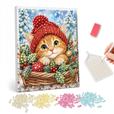 Ginger Kitten in a Holiday Basket pearl painting – Ginger kitten in a red knit hat peeking out of a wicker basket filled with baubles and greenery