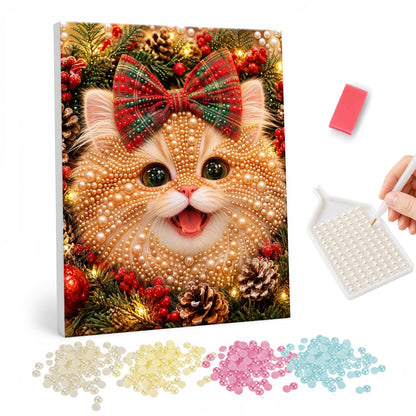 Ginger Kitten with a Tartan Bow pearl painting – Happy ginger kitten with a big tartan bow on its head among holly, berries and pine cones