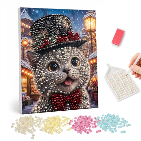 Top-Hat Kitten with a Bow Tie pearl painting – Grey kitten in a holly-trimmed black top hat and red bow tie on a lamplit village street at night