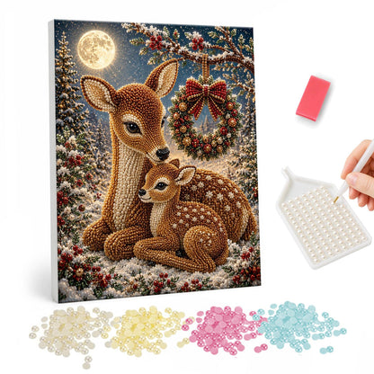 Moonlit Deer Beneath a Wreath pearl painting – Doe and spotted fawn resting in the snow beneath a hanging wreath under a full moon