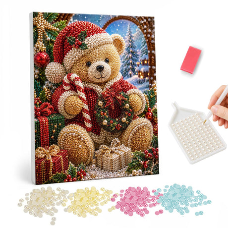 Teddy with Candy Cane and Wreath pearl painting – Teddy bear in a Santa hat holding a candy cane and small wreath among gifts by a snowy arched window