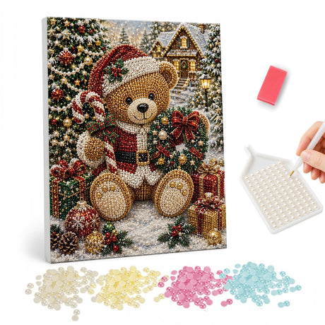 Teddy Bear in a Snowy Village pearl painting – Teddy bear in a Santa hat with a candy cane and wreath sitting among gifts in a snowy village