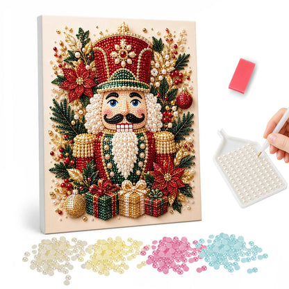 Poinsettia Nutcracker Soldier pearl painting – Mustached nutcracker soldier in a red hat surrounded by poinsettias, holly and gifts on cream