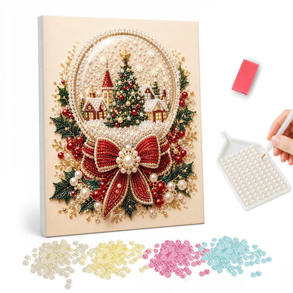 Snow Globe with a Tiny Village pearl painting – Snow globe holding a Christmas tree and red cottages, tied with a red bow and holly on cream