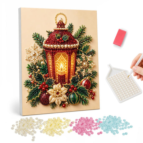 Candlelit Red Lantern pearl painting – Red lantern with a glowing candle surrounded by evergreens, poinsettias and baubles on cream