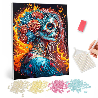 Fire-Wreathed Catrina pearl painting – Woman with sugar skull face paint, red and blue roses in her hair, framed by bright flames