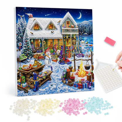 Cottage Yard Winter Feast pearl painting – Snowy cottage with a busy yard of snowman, campfire, sleds and a table of food under a crescent moon