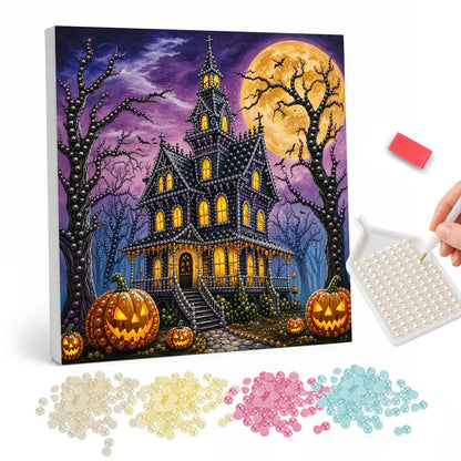 Turreted Haunted House at Night pearl painting – Turreted Victorian haunted house with glowing windows, bare trees and jack-o'-lanterns below a full moon