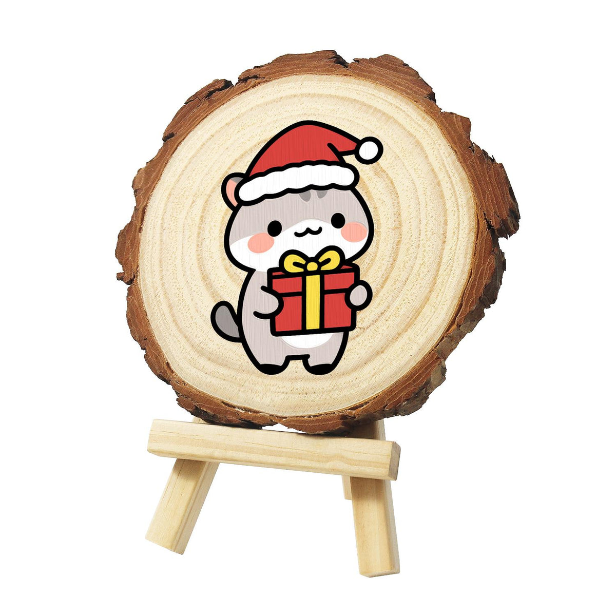Grey Kitten Carrying a Gift paint by numbers wood slice – Grey tabby kitten in a Santa hat holding a red present tied with a yellow ribbon, painted on a pine slice on a small easel