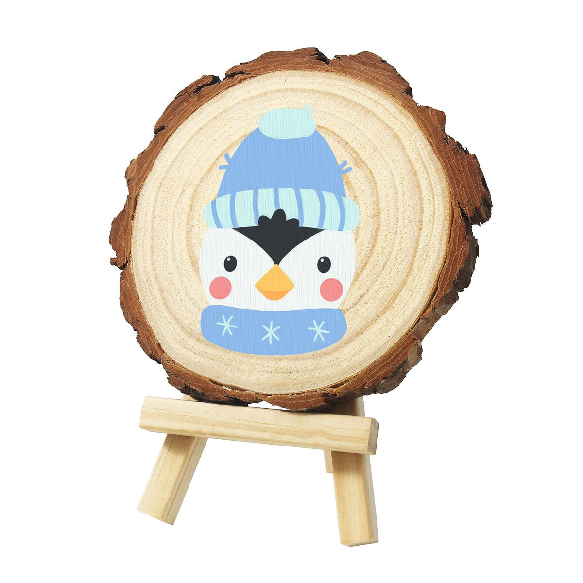 Penguin in a Snowflake Scarf paint by numbers wood slice – Penguin face in a light blue knit bobble hat and a blue scarf with white snowflakes, painted on a pine slice on a small easel