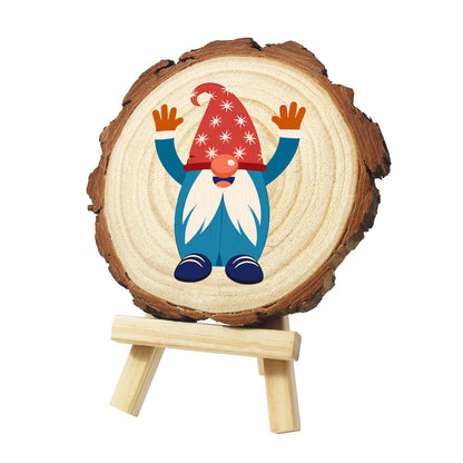 Hands-Up Gnome in a Starry Hat paint by numbers wood slice – Gnome in a red star-patterned hat and blue suit with a long white beard, raising orange-mittened hands, painted on a pine slice on a small easel