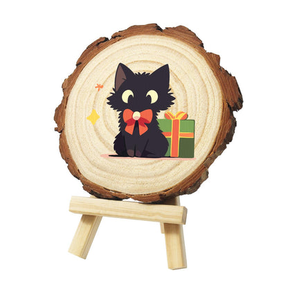 Black Cat with a Green Present paint by numbers wood slice – Fluffy black cat with yellow eyes and a red bow, sitting beside a green gift box with orange ribbon, painted on a pine slice on a small easel